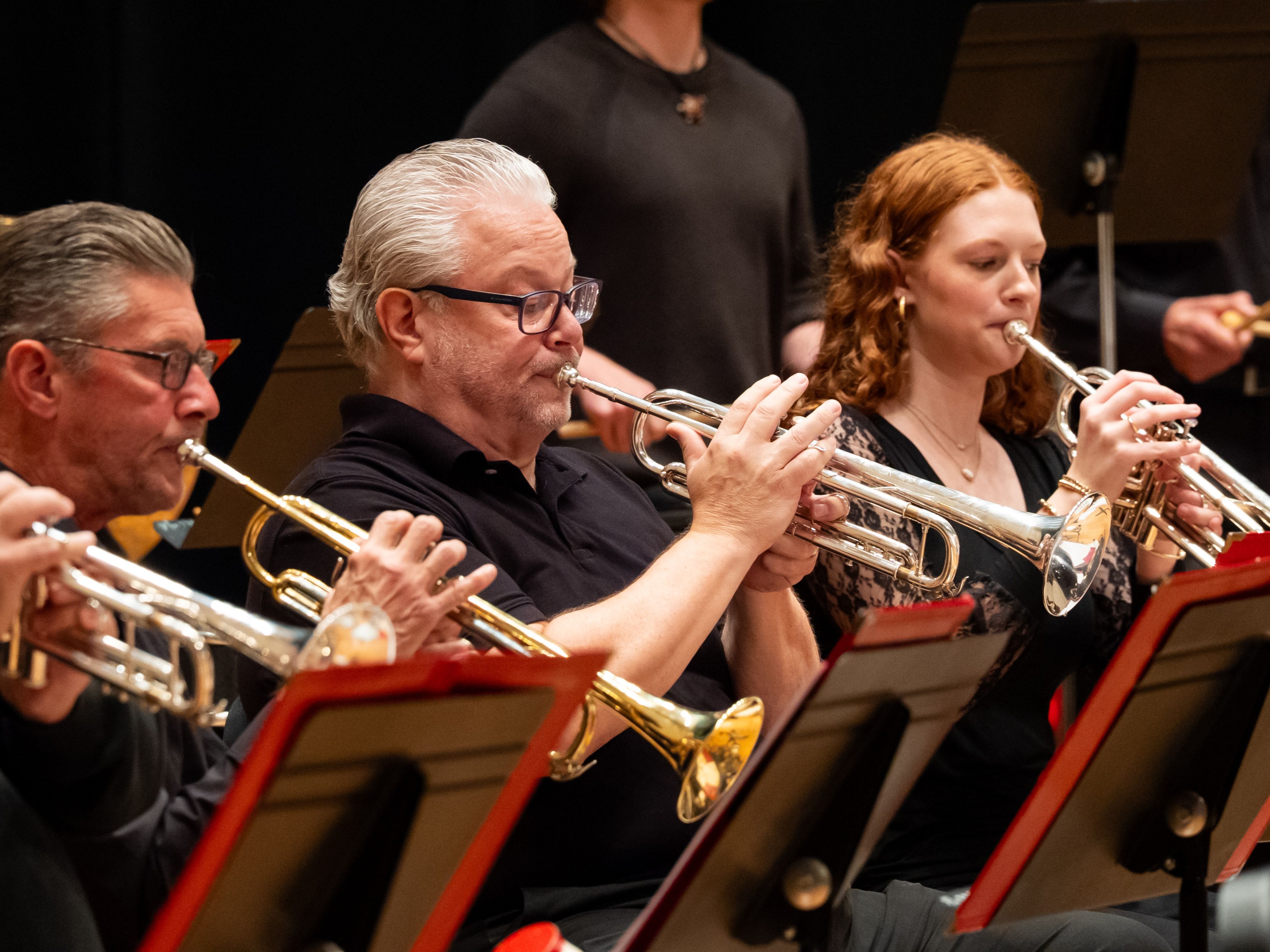 Musicians playing trumpet at a jazz band concert.